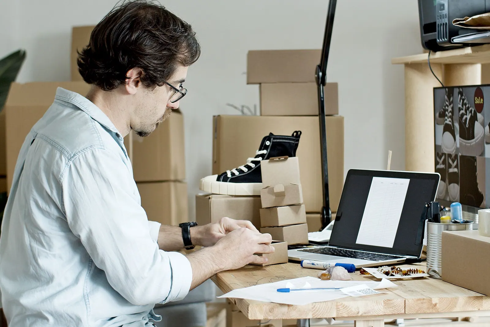 A reseller packing online orders at a desk