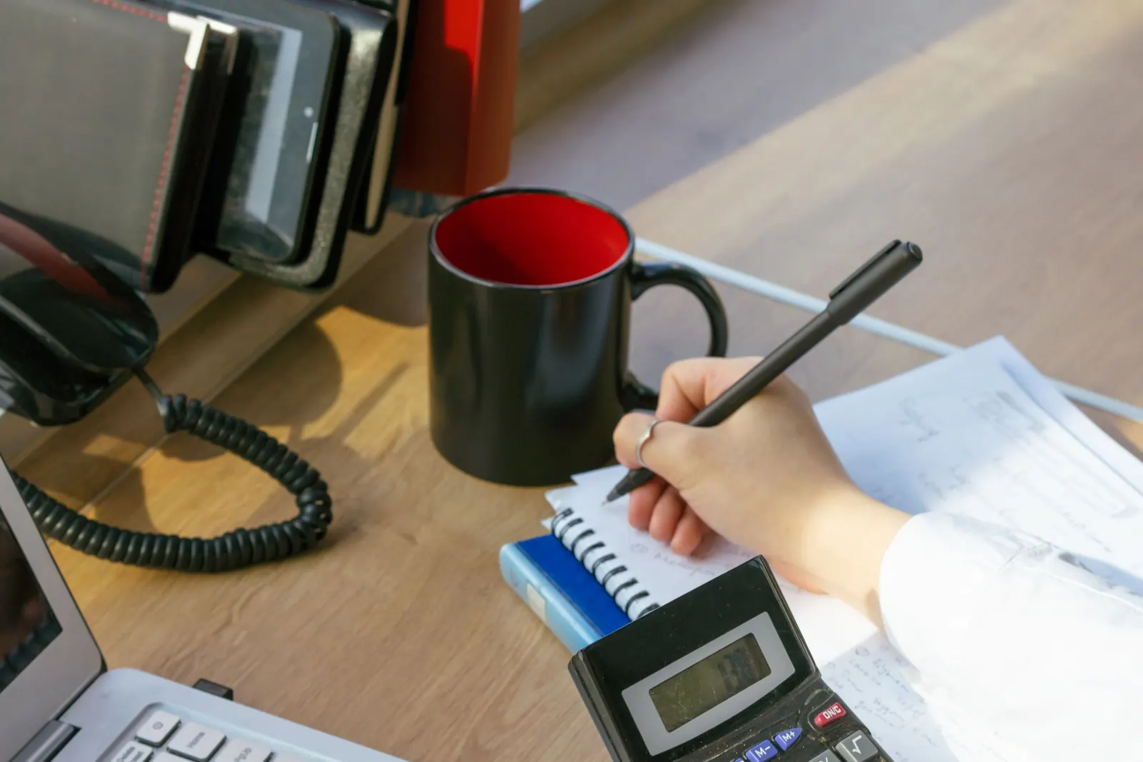 A business owner working through the month&rsquo;s figures