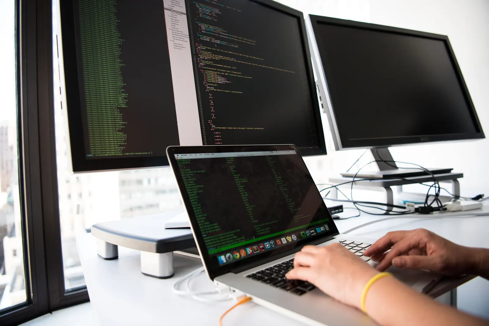 A developer's desk with code on screen — the kind of AI and fintech work Invest NI is backing in Newry