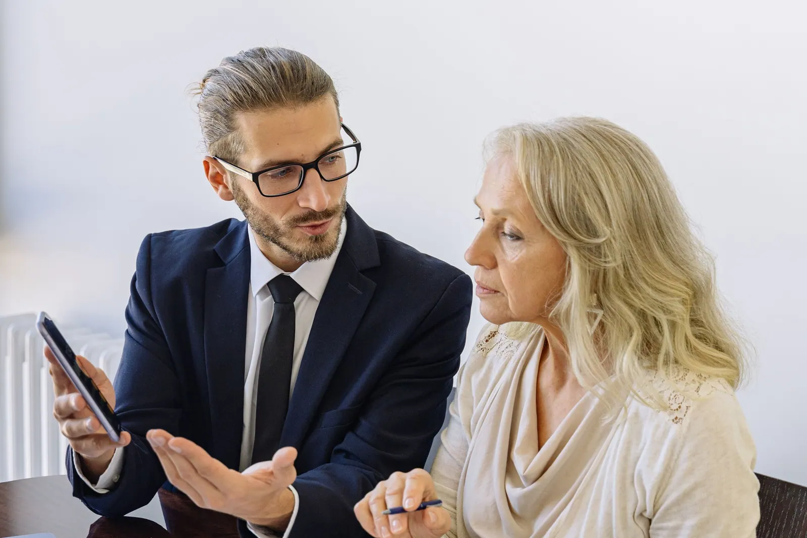 An adviser talking through paperwork with a client