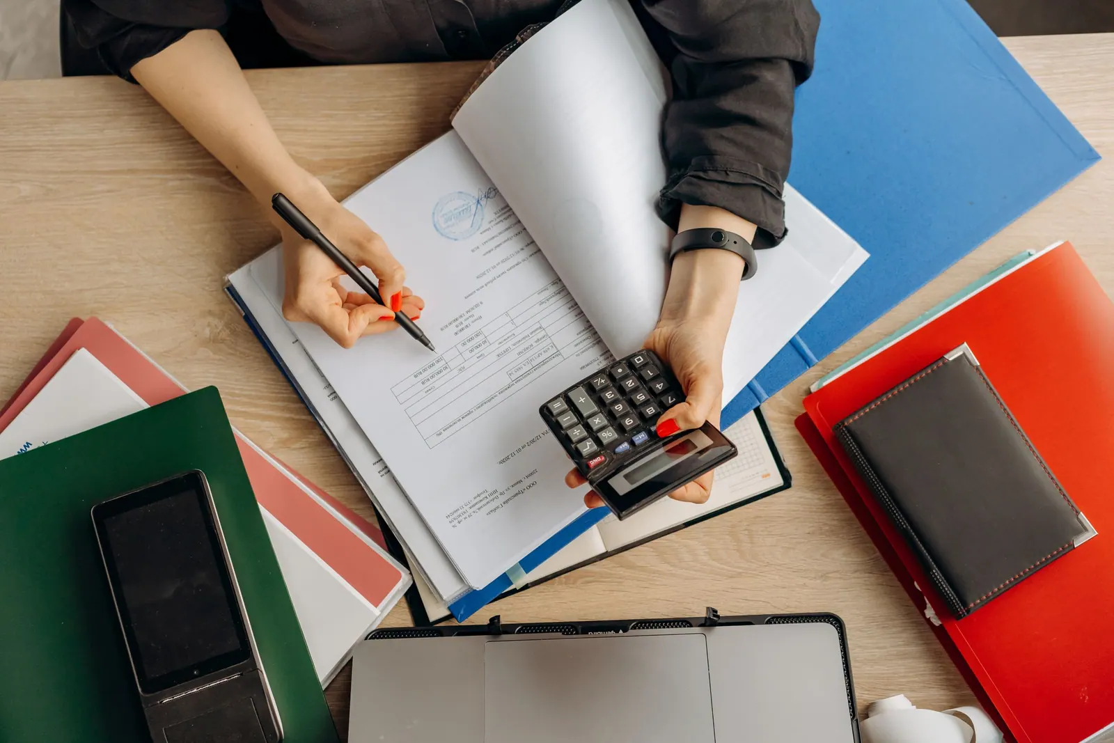 Bookkeeping at a desk with a calculator and receipts