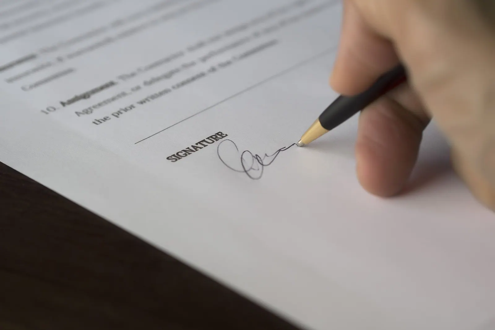 Signing a company document at the desk