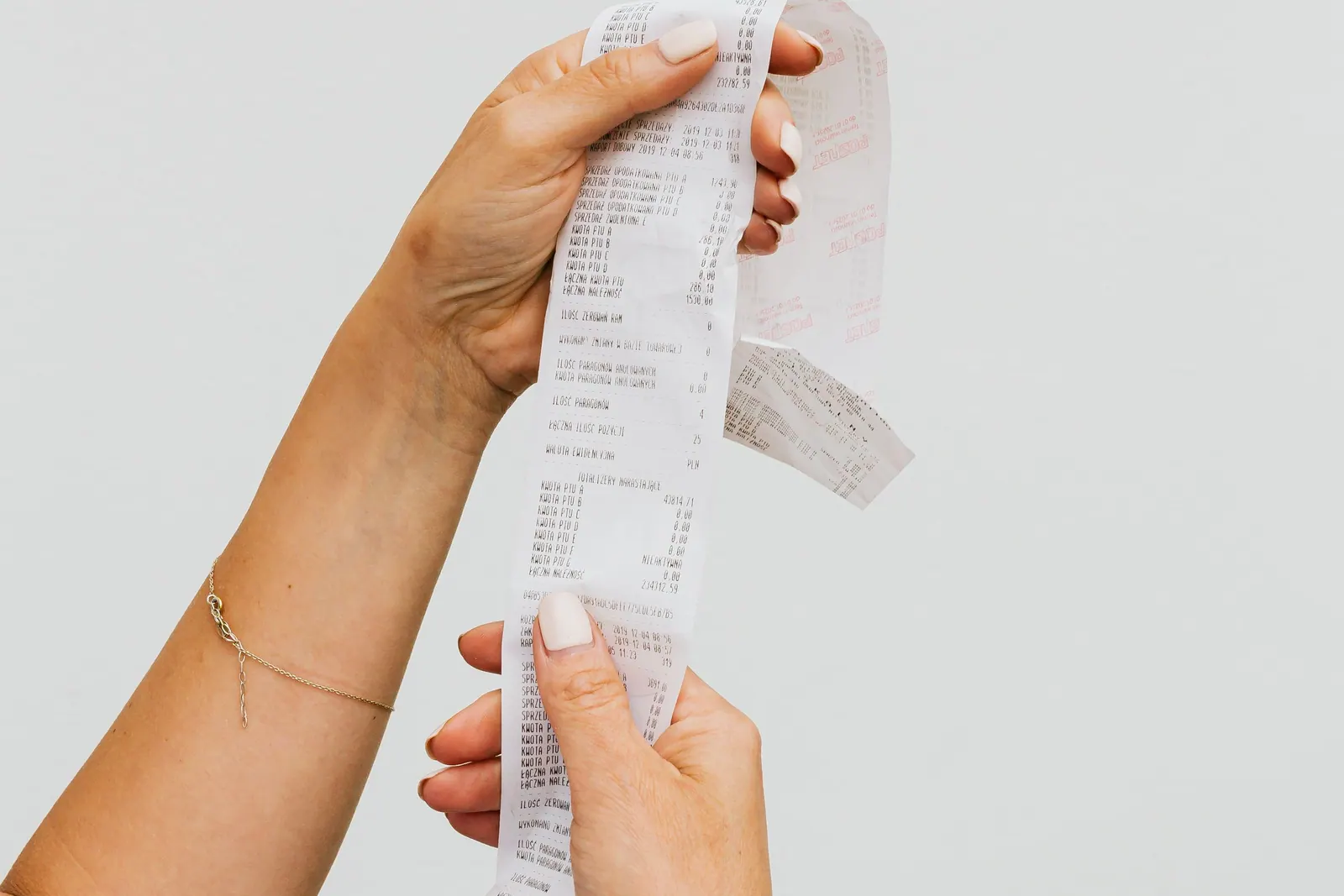 A till receipt being checked by hand
